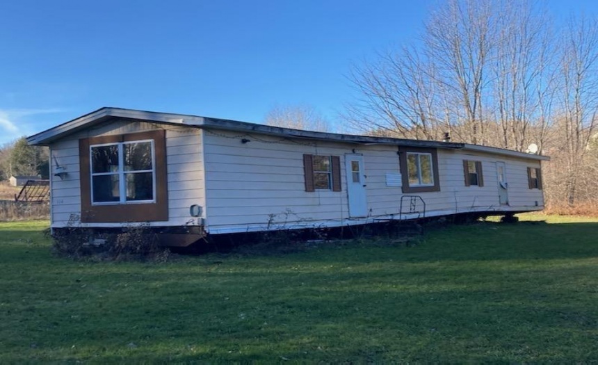 Mobile not hooked to any services located at rear of property above the home site.