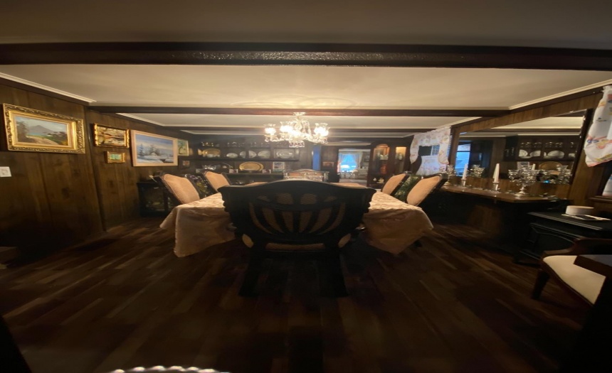 Formal dining room with tons of built in wooden cabinets and shelves.