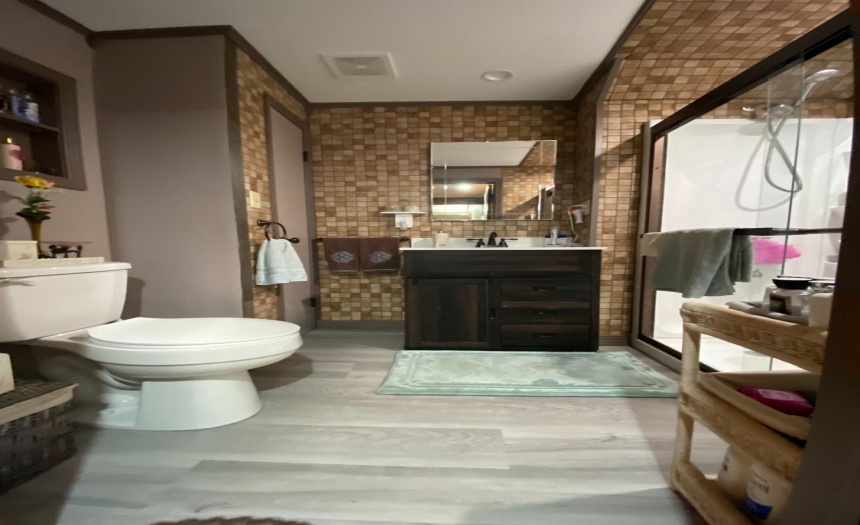 New downstairs bathroom, tiled walls, large walk in shower with handicap bars, glass sliding doors, remodeled 2020,