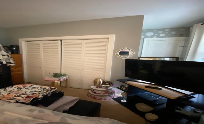 Attic door behind tv stand.