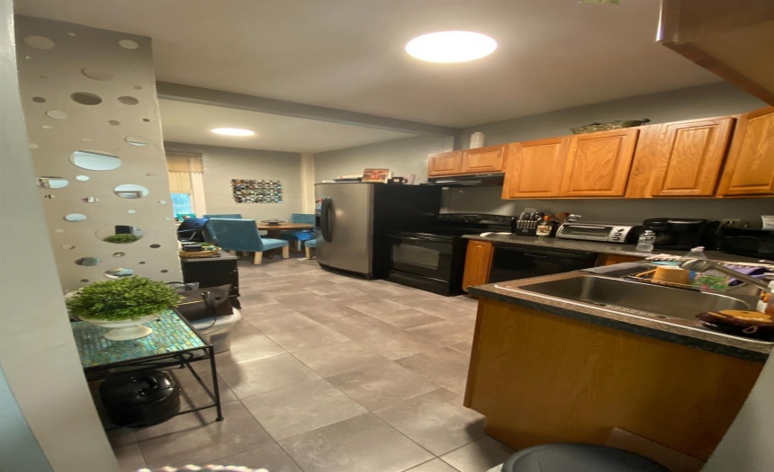 Upstairs kitchen, new tile floor, dishwasher, and oven.