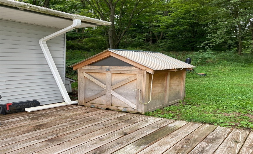 Small storage bay for snow blower, easy access to roll down ramp and get to work!