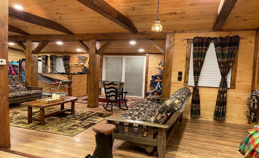 Sliding glass doors lead out to the wraparound deck