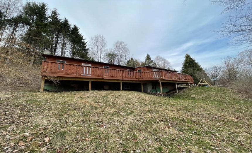 4 Bedroom 1 bathroom custom built log cabin with wraparound deck overlooking the valley leading into Walton in Delaware County, NY. Walkout basement comes out underneath the deck.