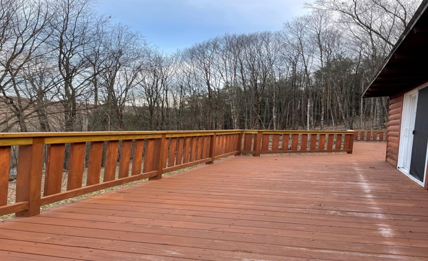 Sliding doors lead out to the large custom built wraparound deck, ovelooking the mountains and valley leading into Walton