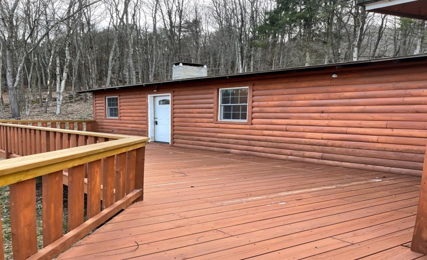 Custom built wraparound deck, seasoned log siding