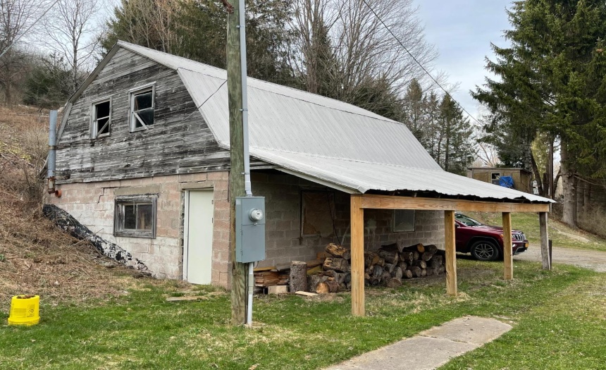 Barn storage out-building made with brick & wood with metal roof, shared driveway