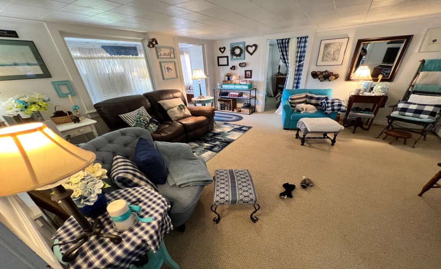 Large living room with new berber carpeting.
