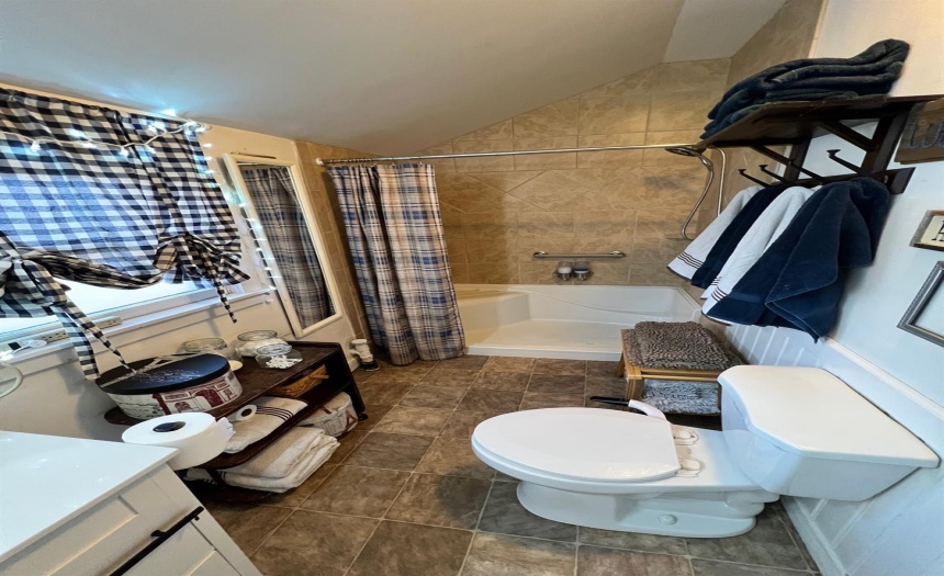 Handicap-accessible seated shower accented with ceramic tile surround.