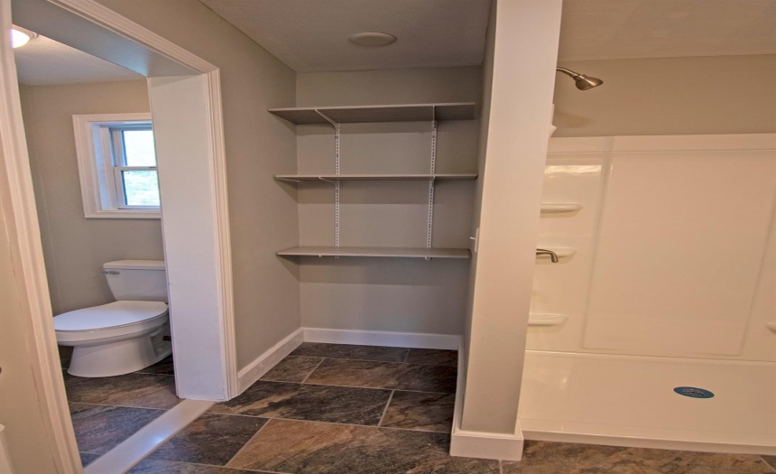 Primary suite bathroom, private toilet stall