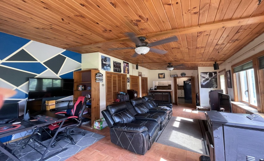 Computer gaming stations, TV room, pellet stove, parquet flooring, ceiling fans... windows, windows, windows!