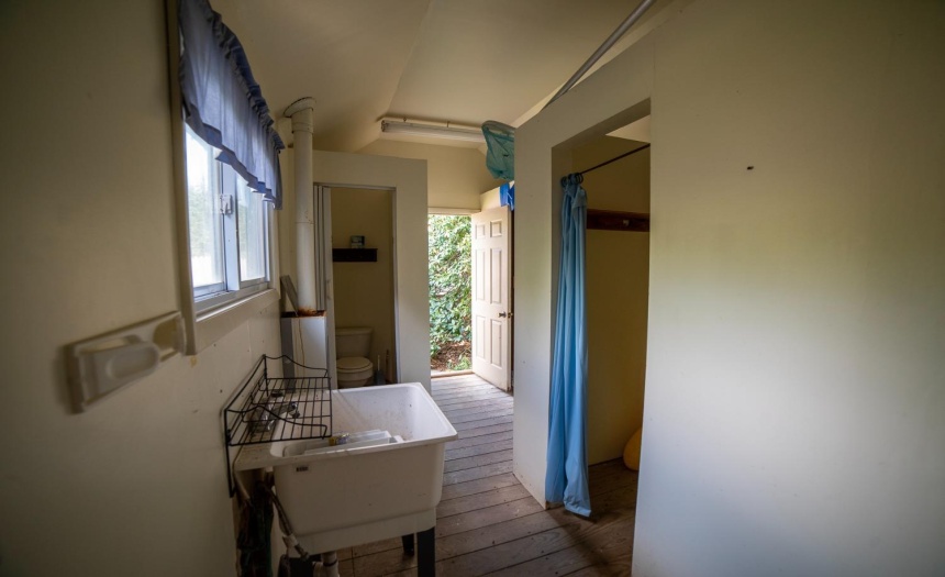 an interior shot of the pool house with dressing rooms and toilet.