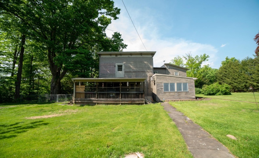 Door over top of the deck roof is off the dressing room.  Plans in the past included adding a rail and putting a hot tub out there.