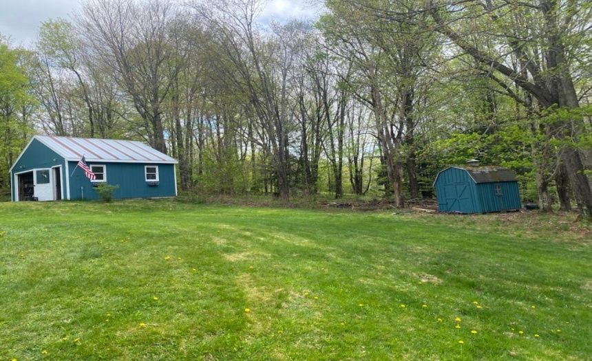 Large garage with insulated shop area plus shed