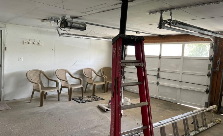 garage in lower level of home. Plenty of space for vehicles, automatic garage door opener