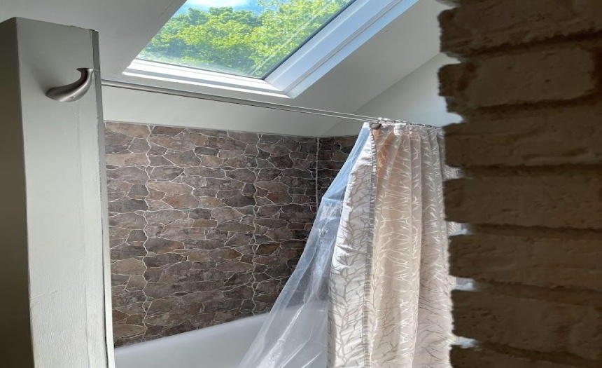 Upstairs bath skylight and tub