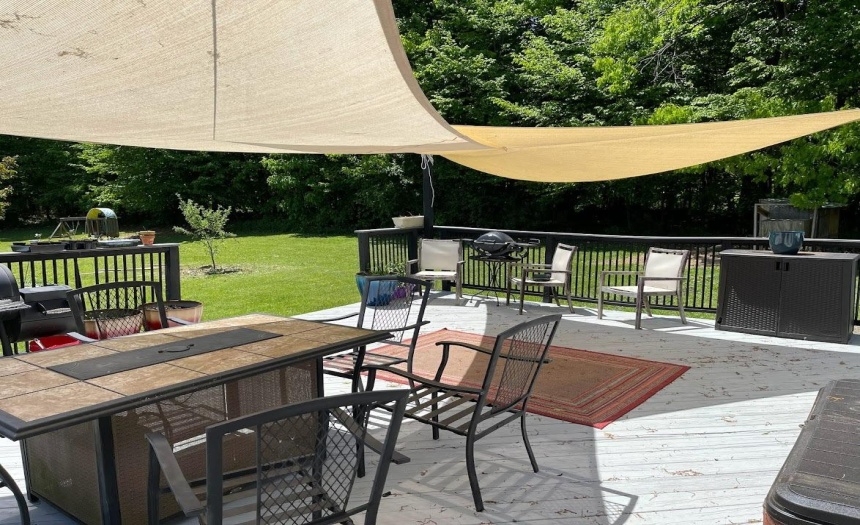 Large rear deck with stairs to the yard and gardens