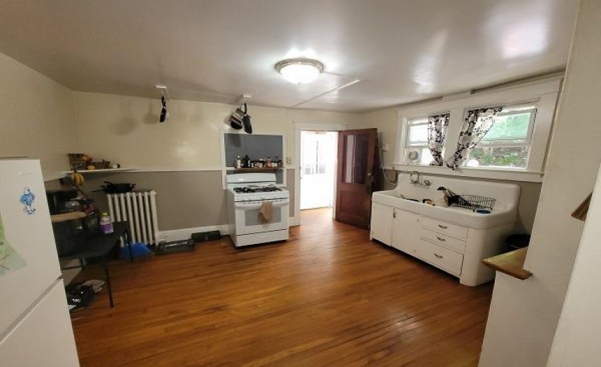 1st floor kitchen with door to back parking area and basement
